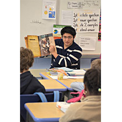Pablo Tutillo '13 reads to fourth graders at New London’s Winthrop Magnet Elementary School.