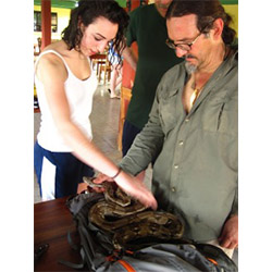 Emma Sherer '13 (left) and Associate Professor of Ethnobotany Manuel Lizarralde check out a six-foot boa constrictor they caught in Belize. 